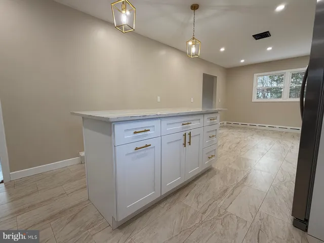 a view of an empty room with a ceiling fan and window