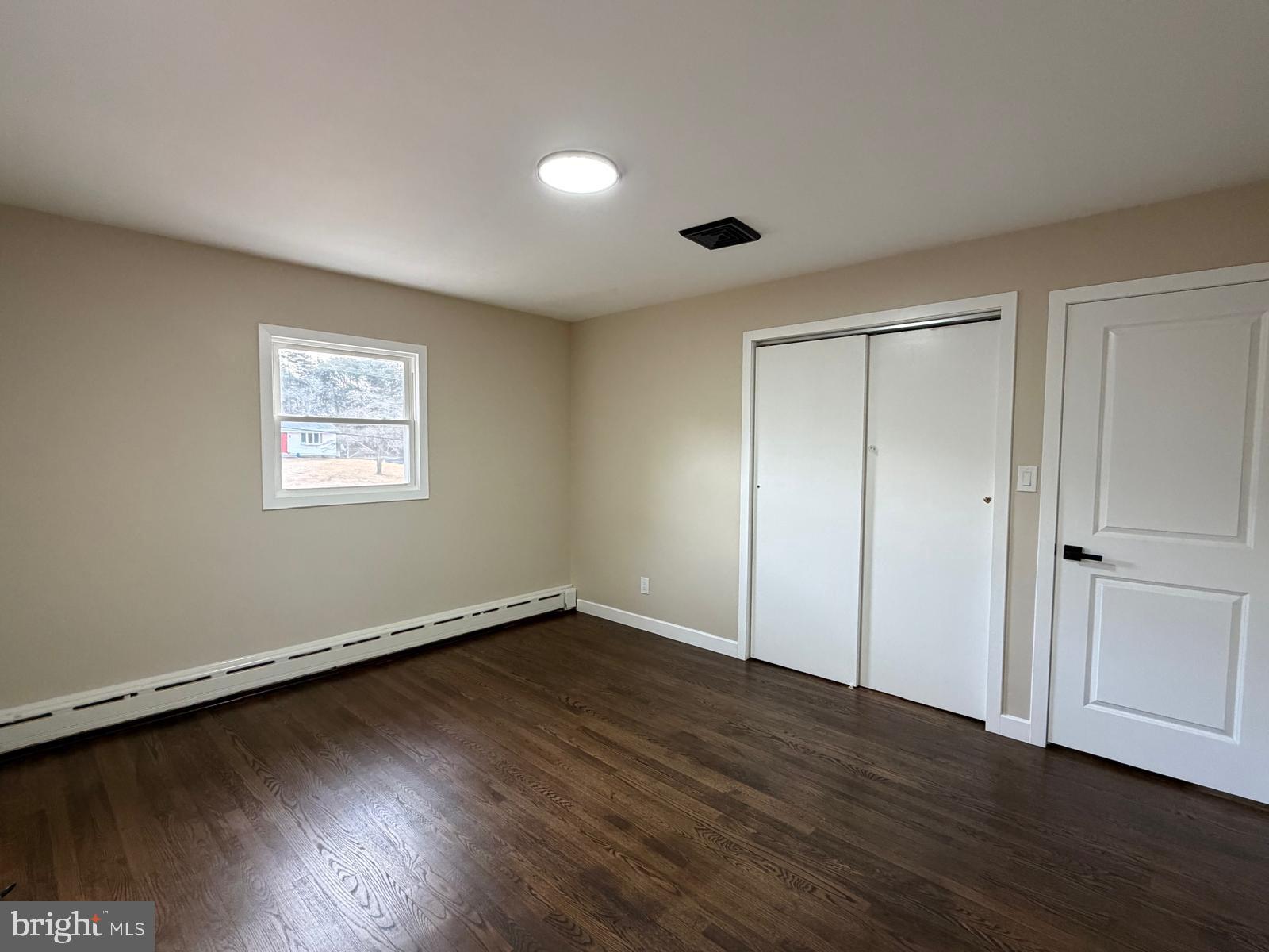 24 Rieck Avenue Millville, NJ 08332 - Photo 26 of 57 a view of an empty room with wooden floor and a window