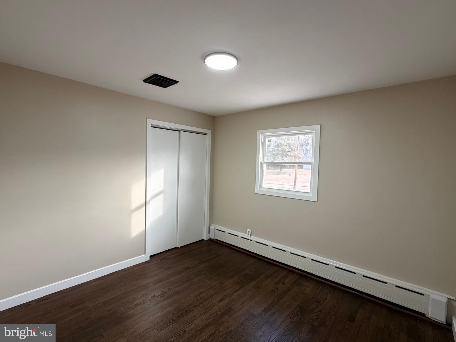 24 Rieck Avenue Millville, NJ 08332 - Photo 27 of 57 an empty room with wooden floor and windows