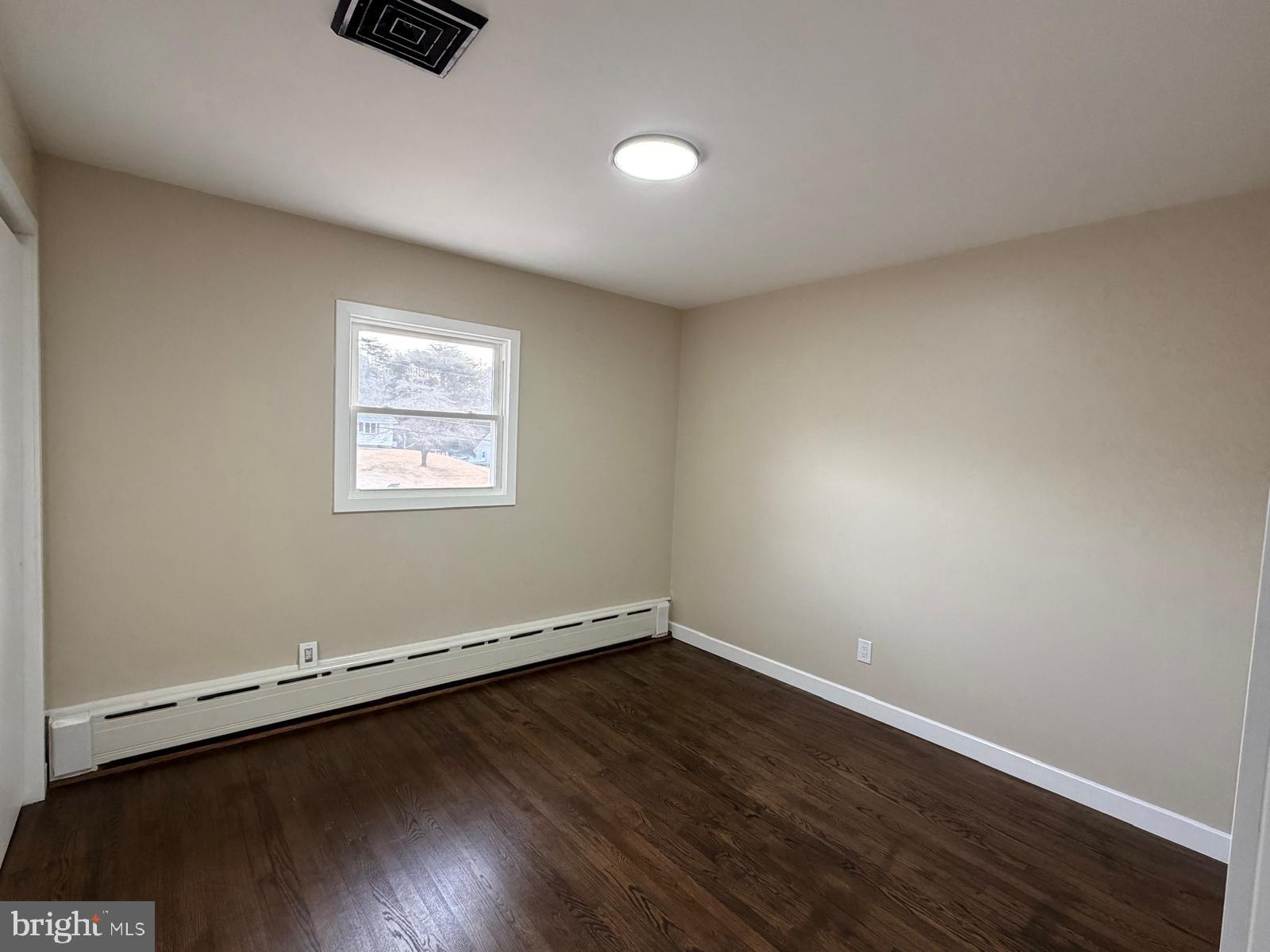 24 Rieck Avenue Millville, NJ 08332 - Photo 28 of 57 an empty room with wooden floor and windows