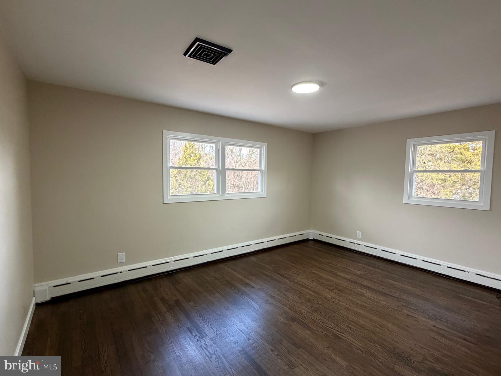 24 Rieck Avenue Millville, NJ 08332 - Photo 29 of 57 a view of an empty room with wooden floor and a window