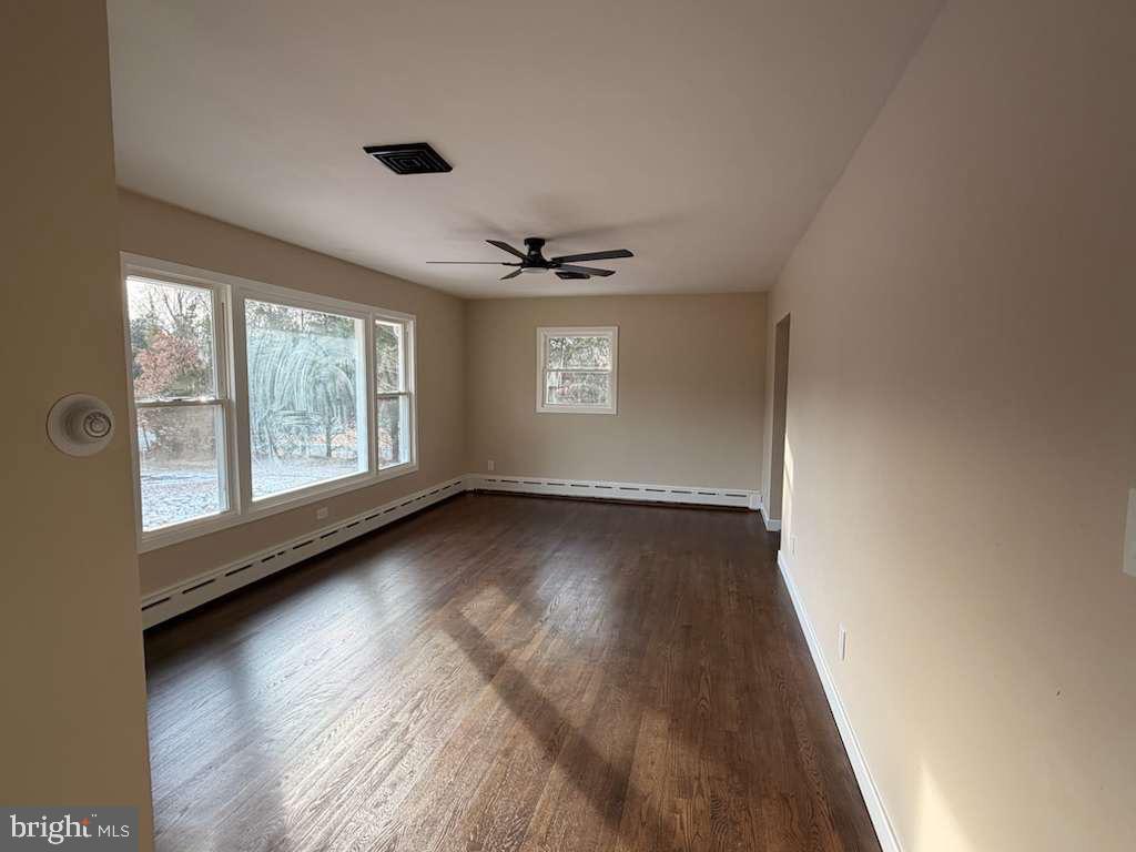 24 Rieck Avenue Millville, NJ 08332 - Photo 4 of 57 an empty room with wooden floor and windows