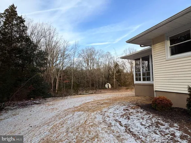 a view of a house with a yard and roof