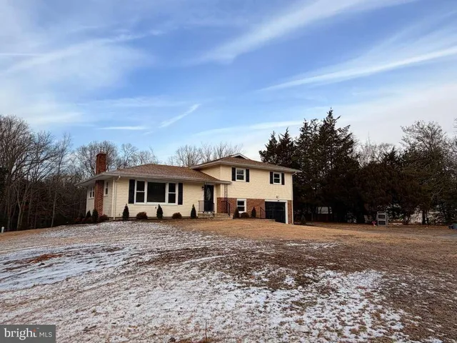 an aerial view of a house with trees