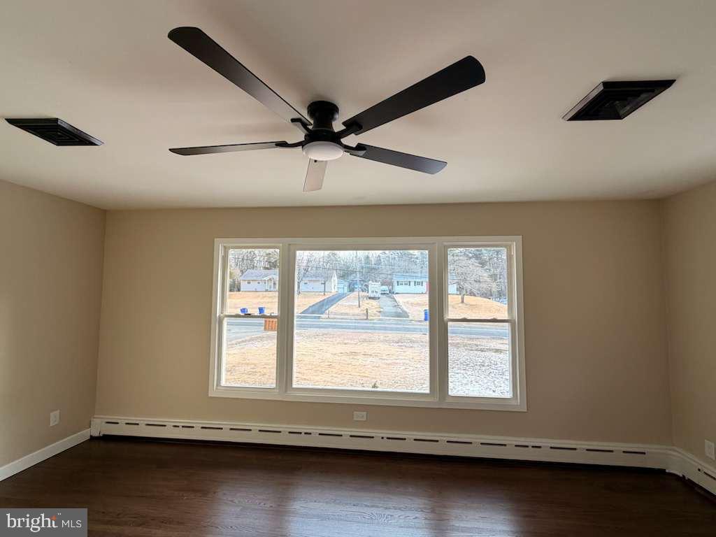 24 Rieck Avenue Millville, NJ 08332 - Photo 5 of 57 a view of an empty room with wooden floor and a window