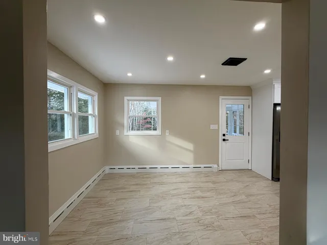 an empty room with windows and closet