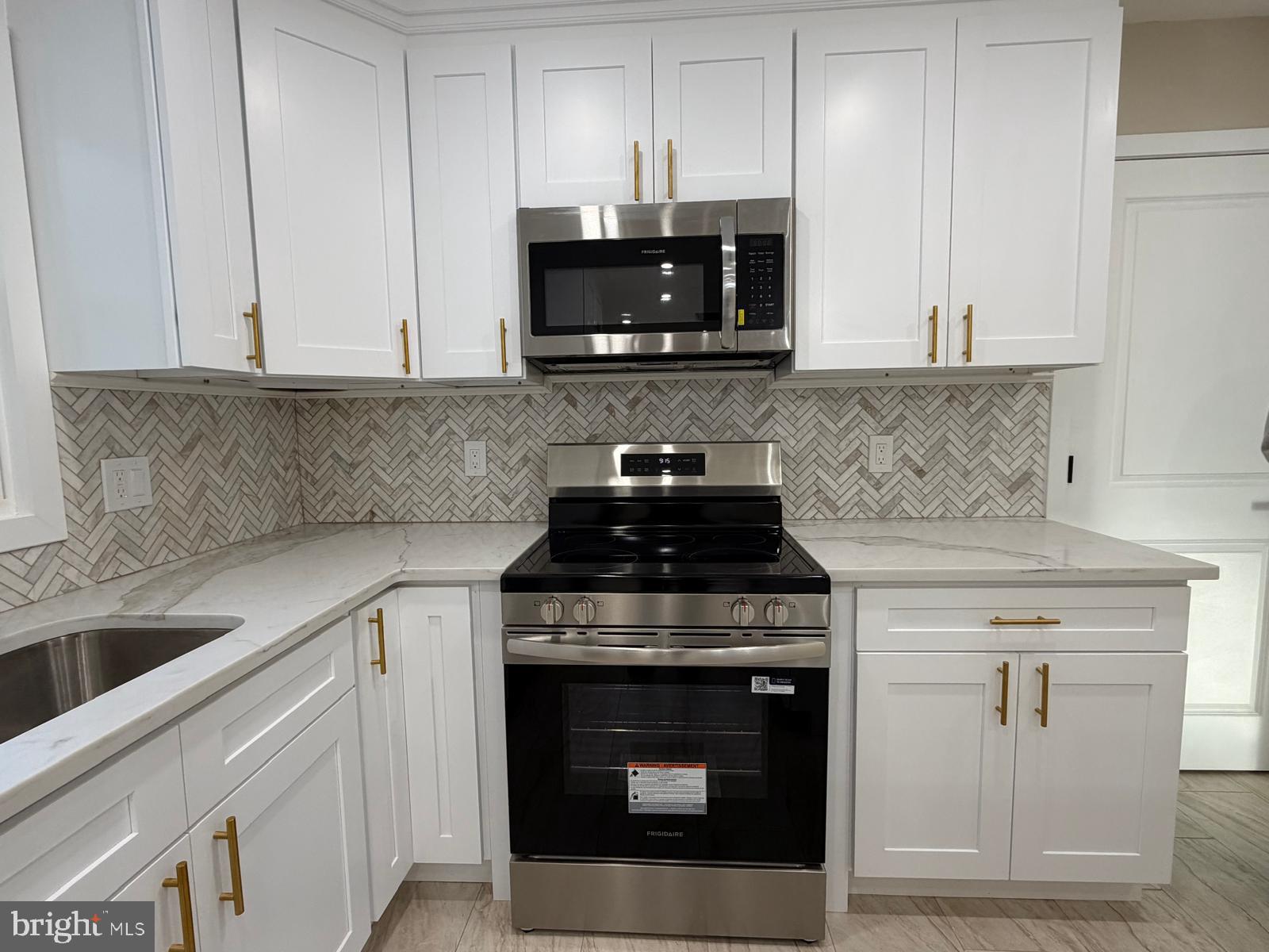 24 Rieck Avenue Millville, NJ 08332 - Photo 10 of 57 a kitchen with stainless steel appliances granite countertop a stove and a microwave