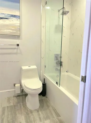 a bathroom with a toilet and a bathtub