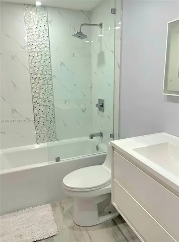 a bathroom with a toilet and a bathtub
