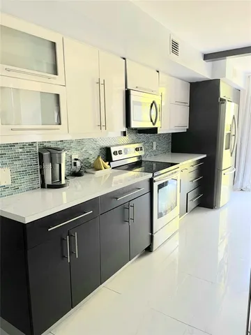 a kitchen with stainless steel appliances a sink stove and refrigerator