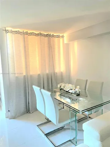 a dining room with furniture and a window