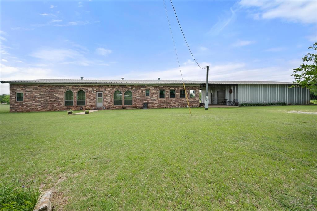 2101 Ridge View Drive Cleburne, TX 76033 - Photo 2 of 31 Expansive brick residence with a metal roof and a large, flat lawn
