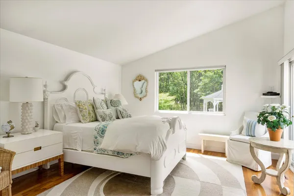 a bedroom with a bed and a table chair