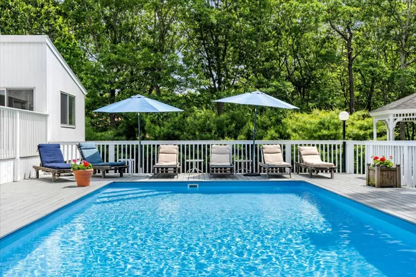 a balcony with view of barbeque oven and trees