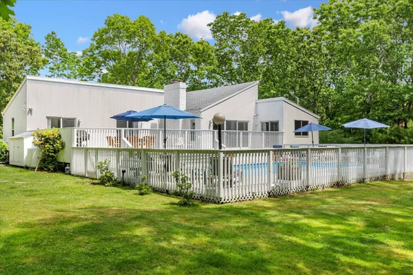 a view of a house with a yard and sitting area