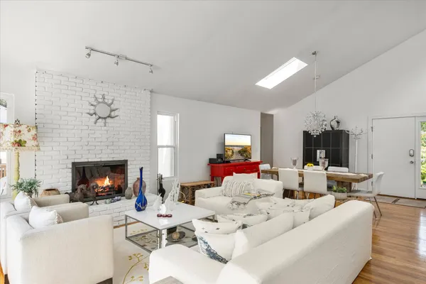 a living room with furniture fireplace and window