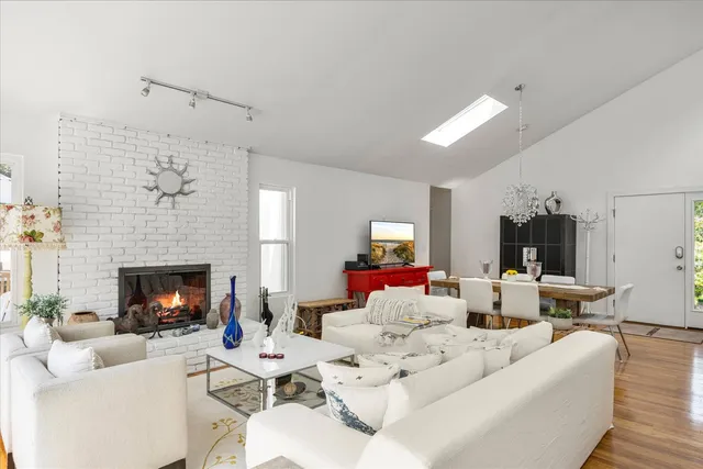 a living room with furniture fireplace and window