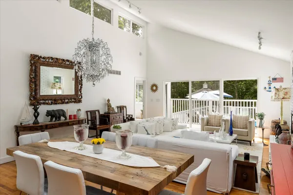 a view of a dining room with furniture and chandelier