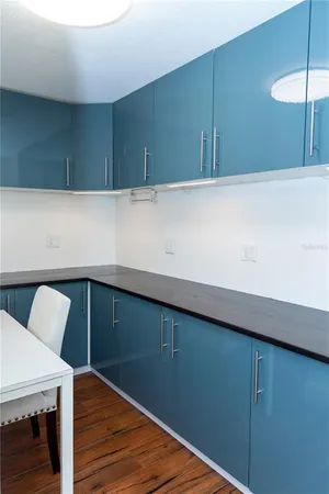 a view of kitchen cabinets and wooden floor
