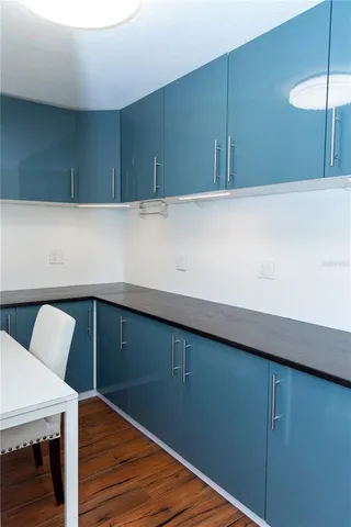 a view of kitchen cabinets and wooden floor