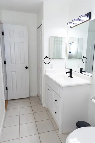 a bathroom with a sink a toilet and mirror