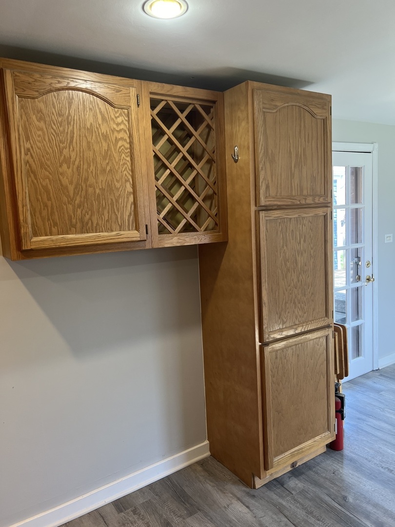 207 Second Street Elgin, IL 60123 - Photo 11 of 23 a view of a refrigerator in kitchen with a wooden floor and a window