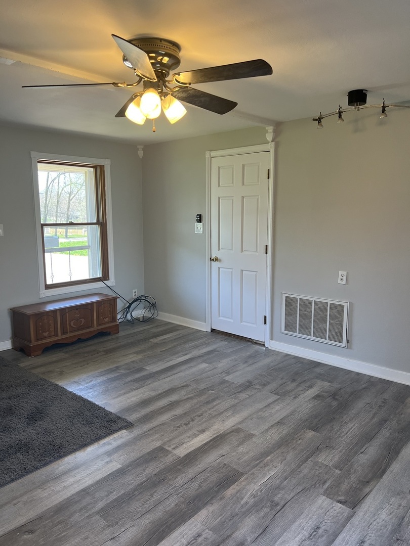 207 Second Street Elgin, IL 60123 - Photo 5 of 23 a view of a livingroom with a window and wooden floor