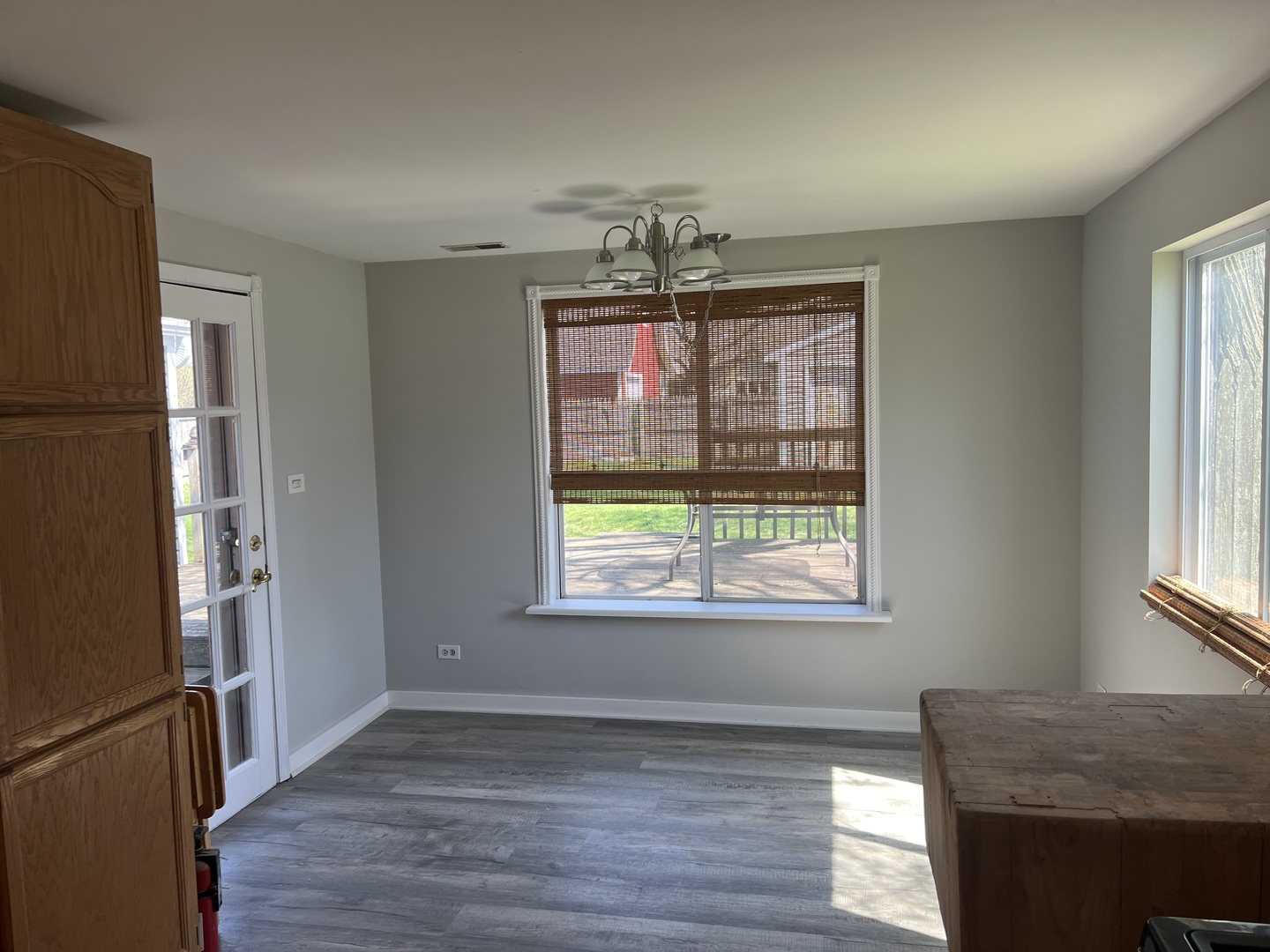 207 Second Street Elgin, IL 60123 - Photo 8 of 23 a view of an empty room with wooden floor and a window