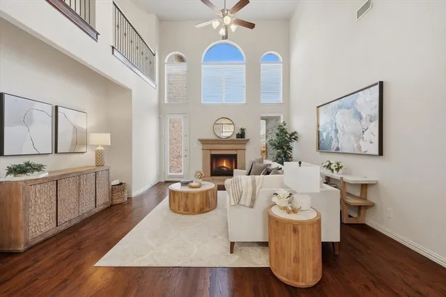 a living room with furniture a fireplace and a chandelier