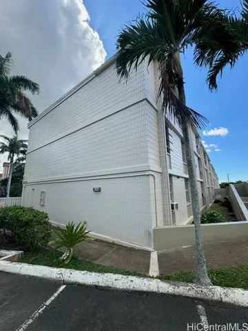 a palm tree sitting in front of a house