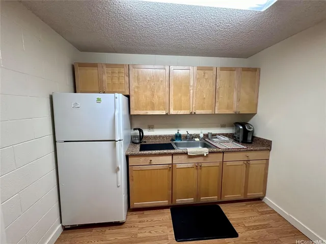 a kitchen with a refrigerator and a sink