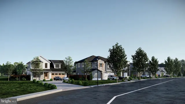 a front view of a house with a garden and tree