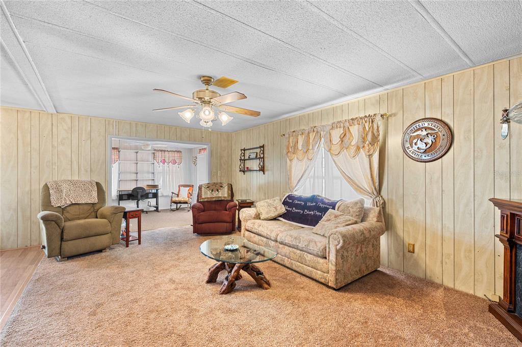 7135 El Dewitt Street Zephyrhills, FL 33541 - Photo 14 of 46 a living room with furniture and a large window