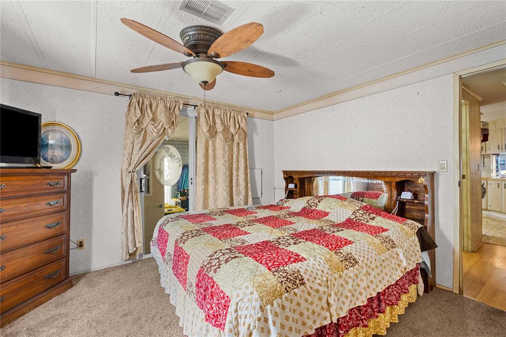 7135 El Dewitt Street Zephyrhills, FL 33541 - Photo 17 of 46 a bedroom with a bed and a chandelier
