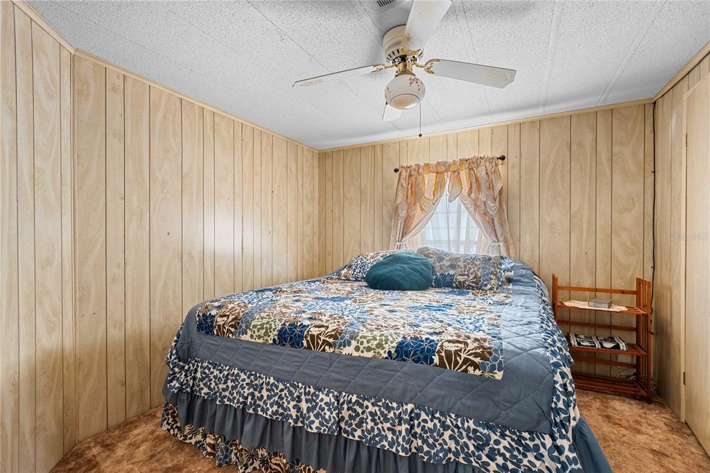 7135 El Dewitt Street Zephyrhills, FL 33541 - Photo 19 of 46 a bedroom with a bed and a table