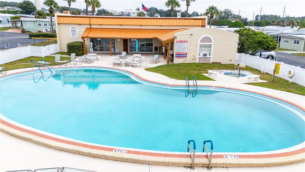 7135 El Dewitt Street Zephyrhills, FL 33541 - Photo 29 of 46 a view of a swimming pool with a lounge chairs