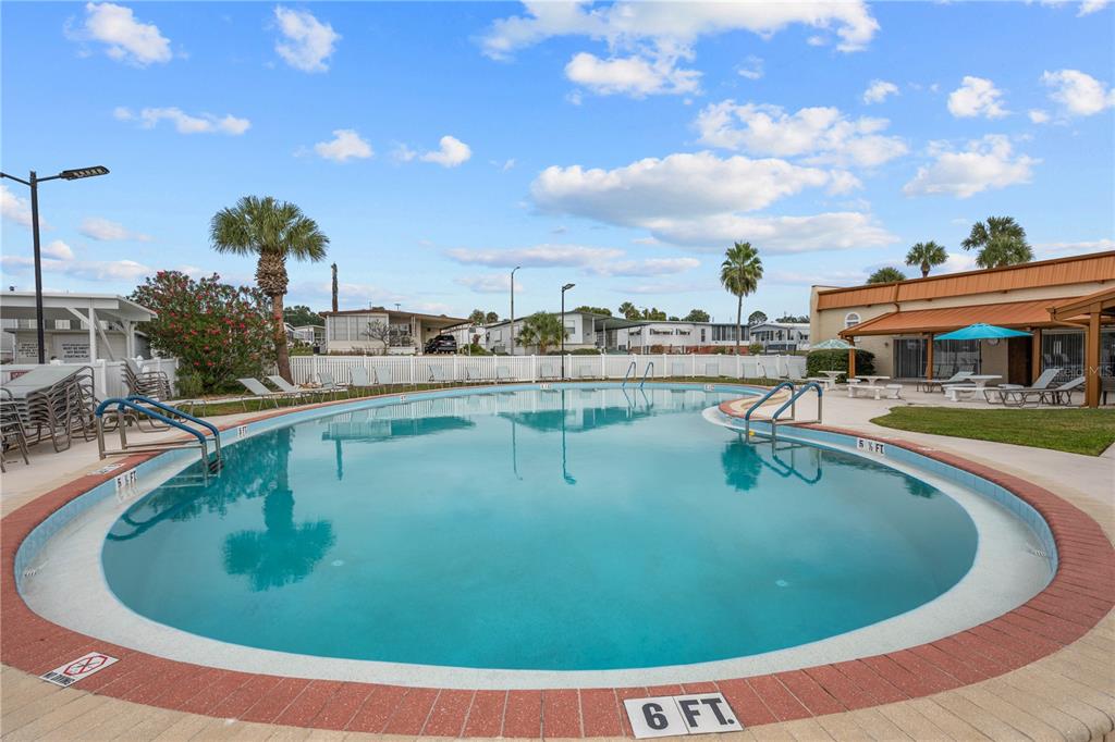 7135 El Dewitt Street Zephyrhills, FL 33541 - Photo 34 of 46 a view of a swimming pool with outdoor seating