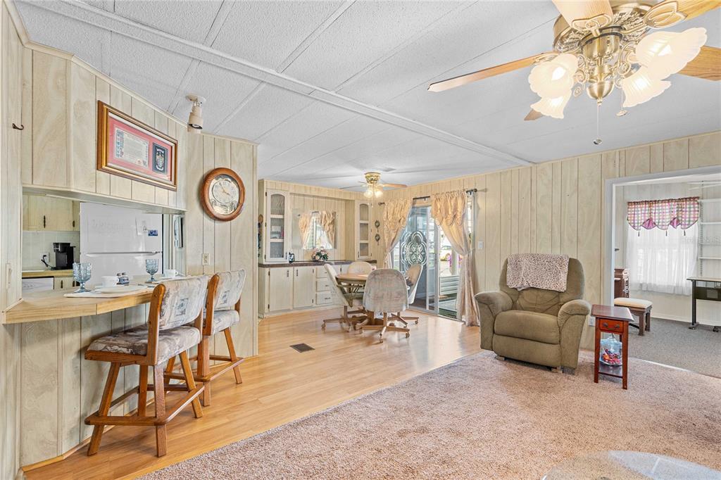 7135 El Dewitt Street Zephyrhills, FL 33541 - Photo 10 of 46 a living room with furniture a clock on wall and a clock