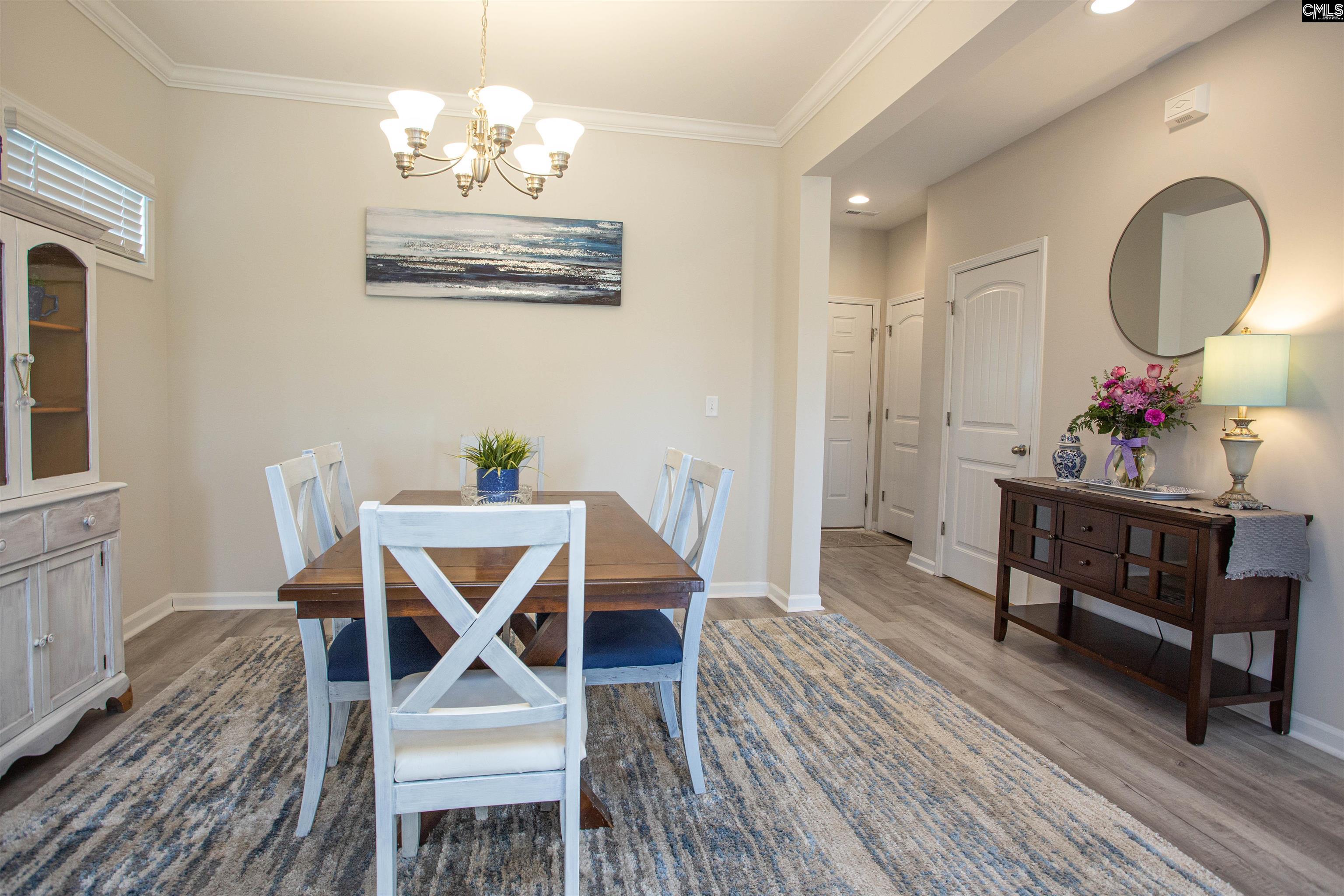 272 Shadowbrook Way Camden, SC 29020 - Photo 4 of 43 a view of a dining room with furniture wooden floor and a chandelier