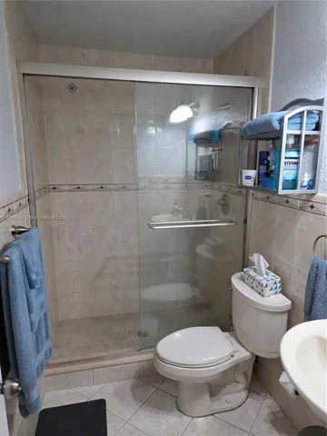 a bed sitting in a bedroom next to a lamp