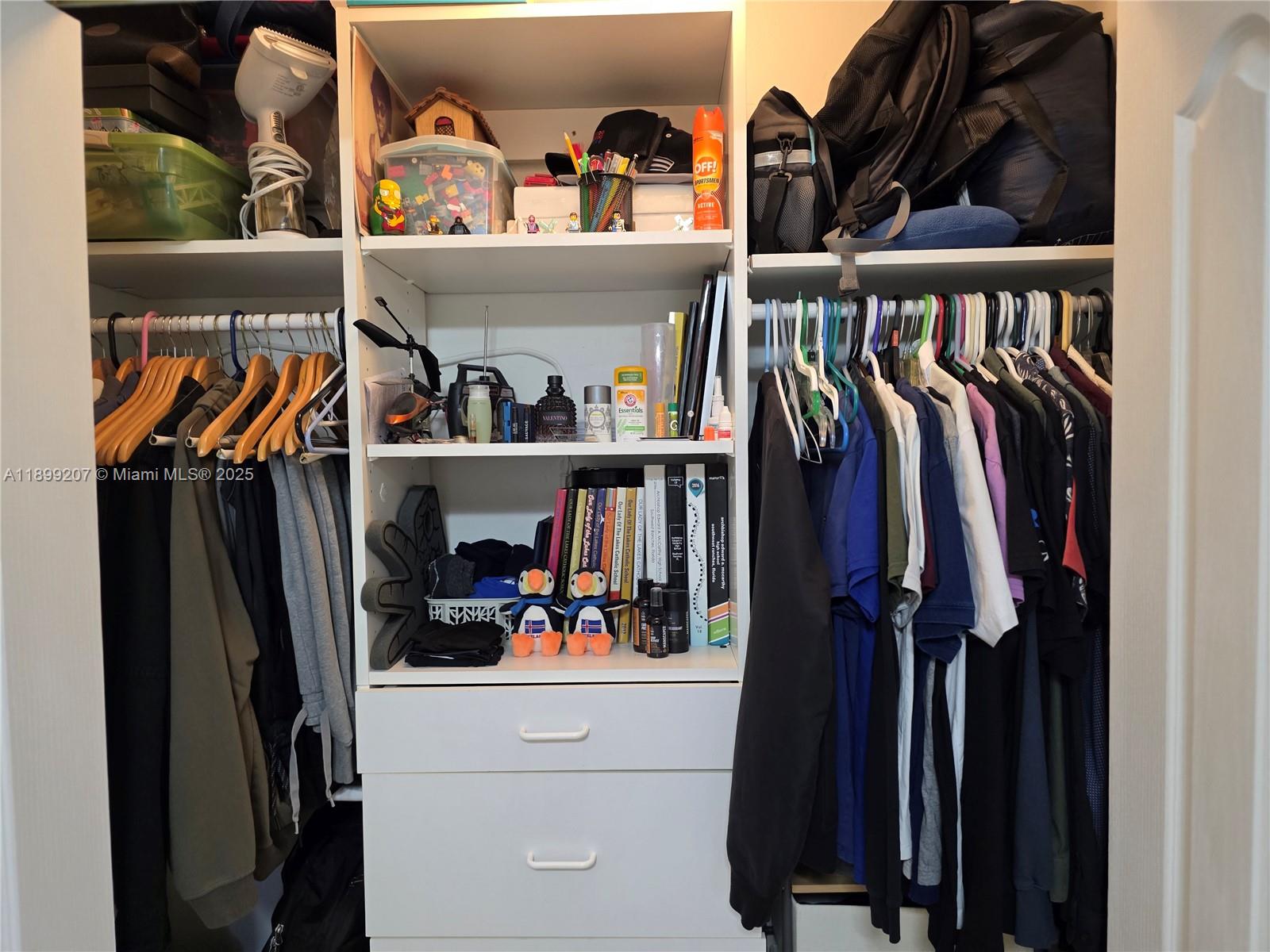 6923 Holly Road Miami Lakes, FL 33014 - Photo 15 of 23 a view of walk in closet with clothes and shoes