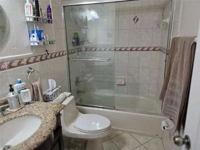 a view of a dining room with furniture and a floor to ceiling window