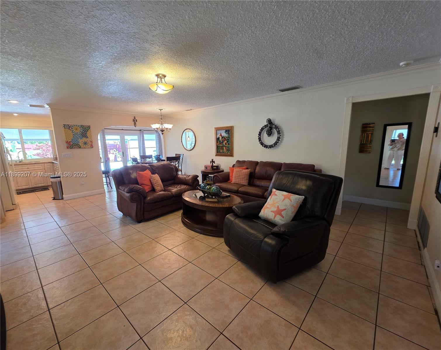 6923 Holly Road Miami Lakes, FL 33014 - Photo 3 of 23 a living room with furniture and a flat screen tv