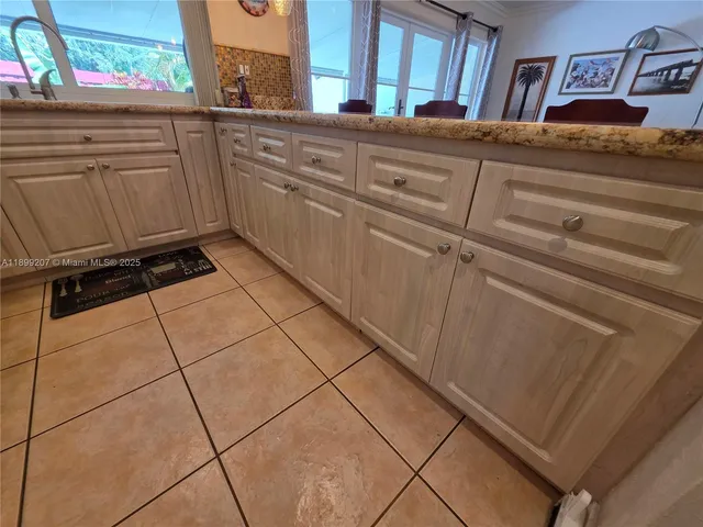 a view of a livingroom with wooden floor and a rug