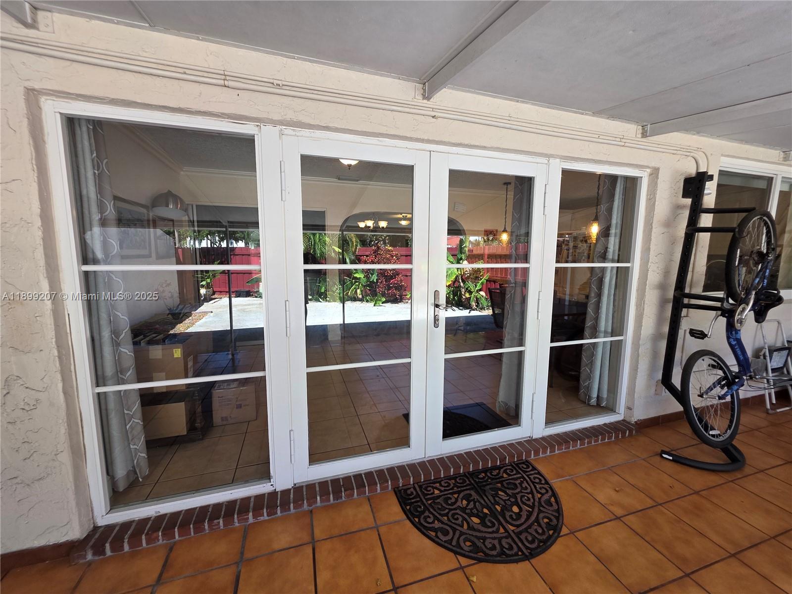 6923 Holly Road Miami Lakes, FL 33014 - Photo 7 of 23 a view of a livingroom with wooden floor and a rug