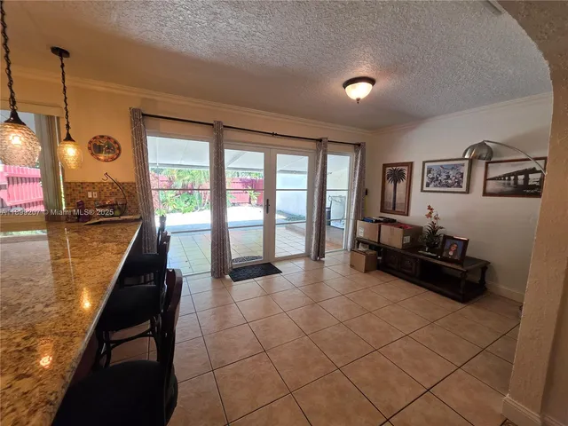 a kitchen with granite countertop a refrigerator and a stove