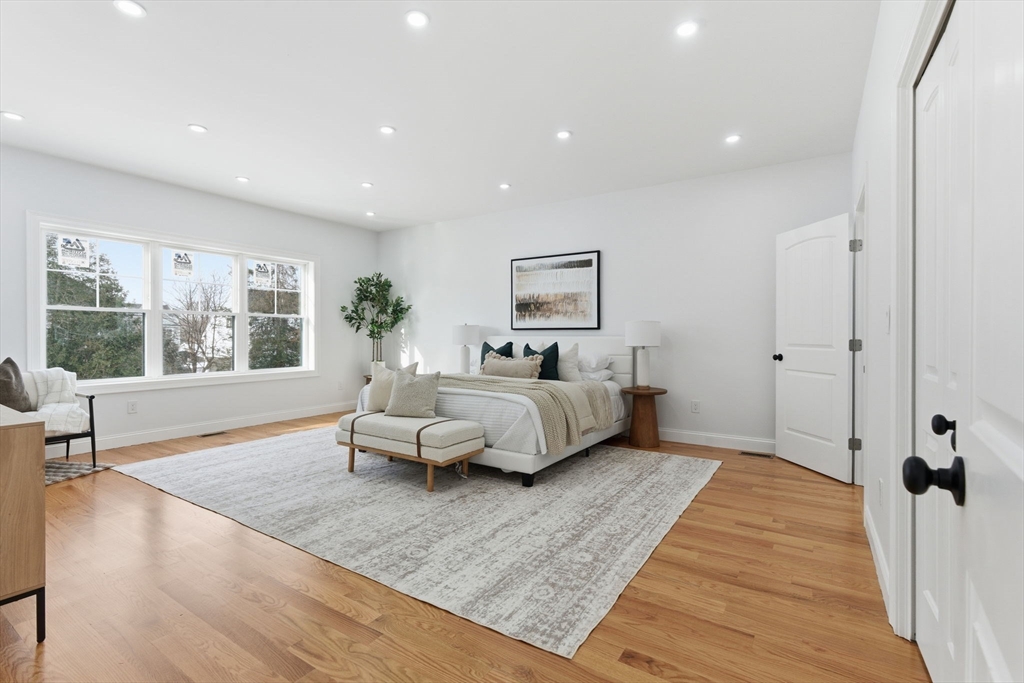 251 Clark Road Lowell, MA 01852 - Photo 15 of 36 a spacious bedroom with a bed a couch and a window with outer view