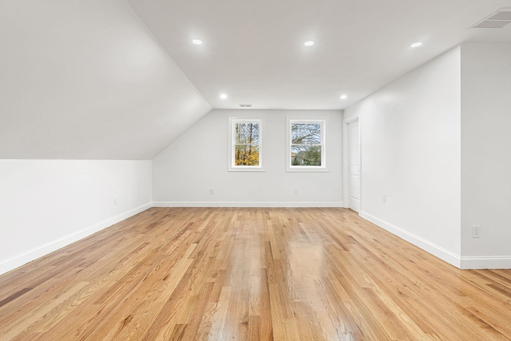 251 Clark Road Lowell, MA 01852 - Photo 29 of 36 an empty room with wooden floor and windows