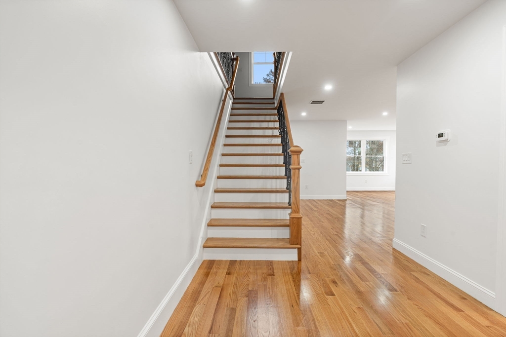 251 Clark Road Lowell, MA 01852 - Photo 32 of 36 a view of a hallway with wooden floor and staircase