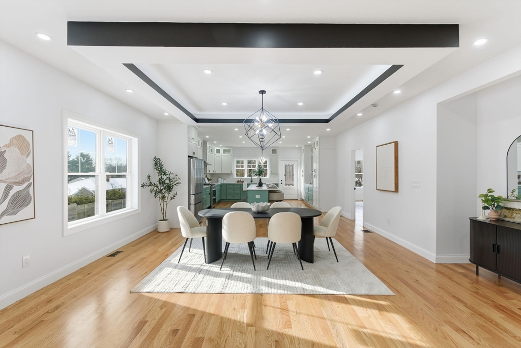 251 Clark Road Lowell, MA 01852 - Photo 4 of 36 a view of a dining room with furniture a rug and wooden floor